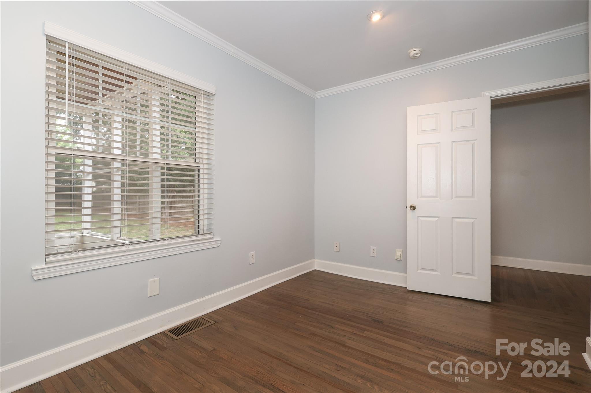 2012 Scott Avenue Charlotte, NC 28203 - Photo 34 of 43 a view of an empty room with wooden floor and a window