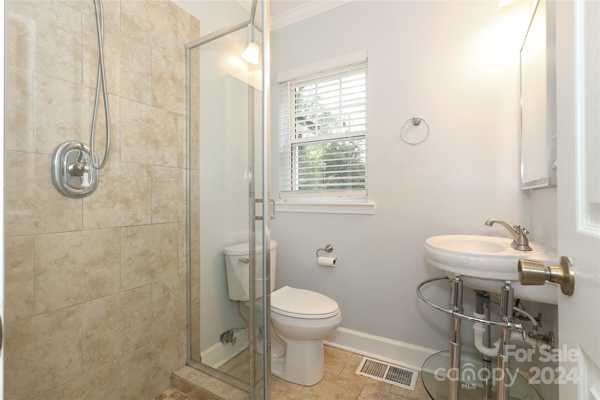 2012 Scott Avenue Charlotte, NC 28203 - Photo 35 of 43 a bathroom with a toilet a sink and a shower