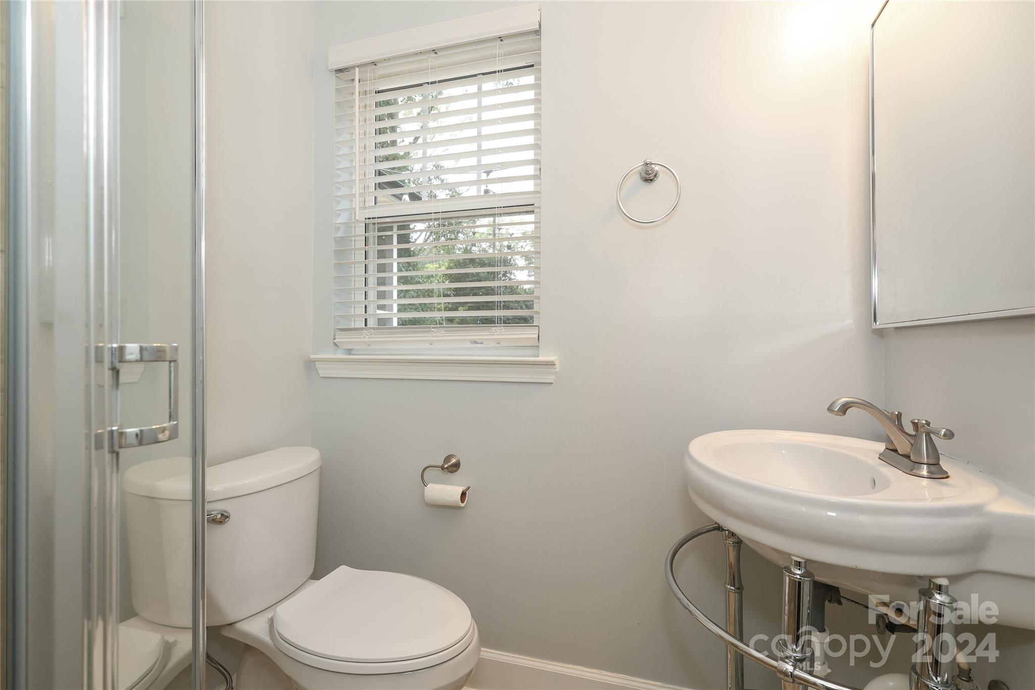 2012 Scott Avenue Charlotte, NC 28203 - Photo 36 of 43 a bathroom with a sink a toilet and shower