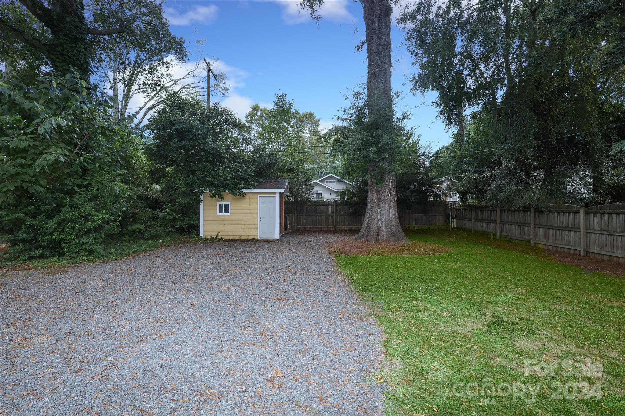 2012 Scott Avenue Charlotte, NC 28203 - Photo 42 of 43 a front view of a house with a yard and a tree