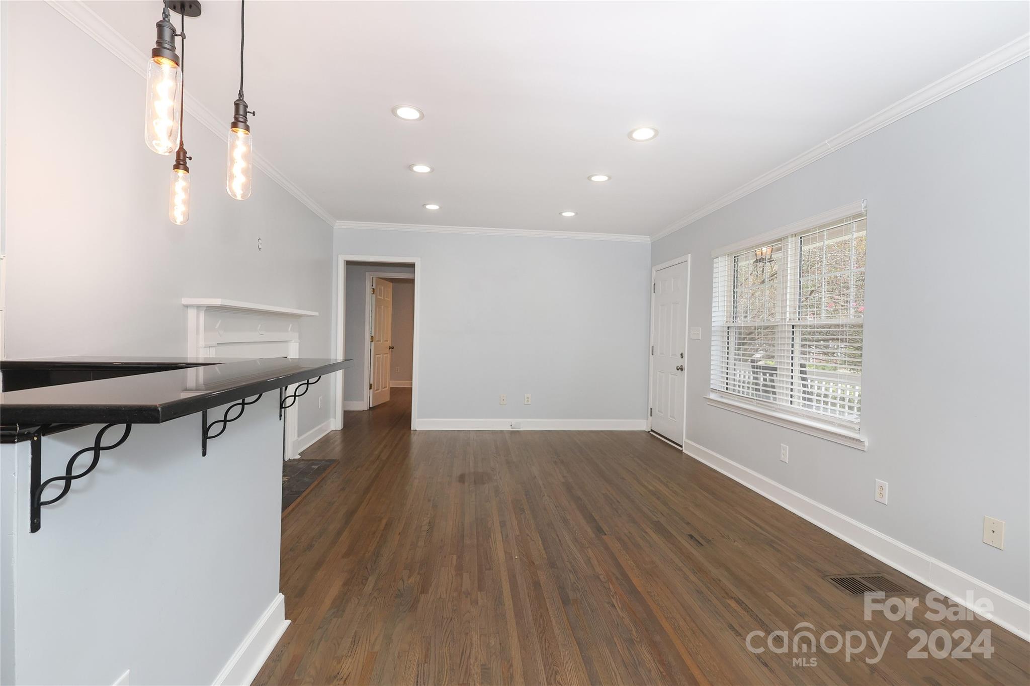 2012 Scott Avenue Charlotte, NC 28203 - Photo 7 of 43 a view of an empty room with wooden floor and a window