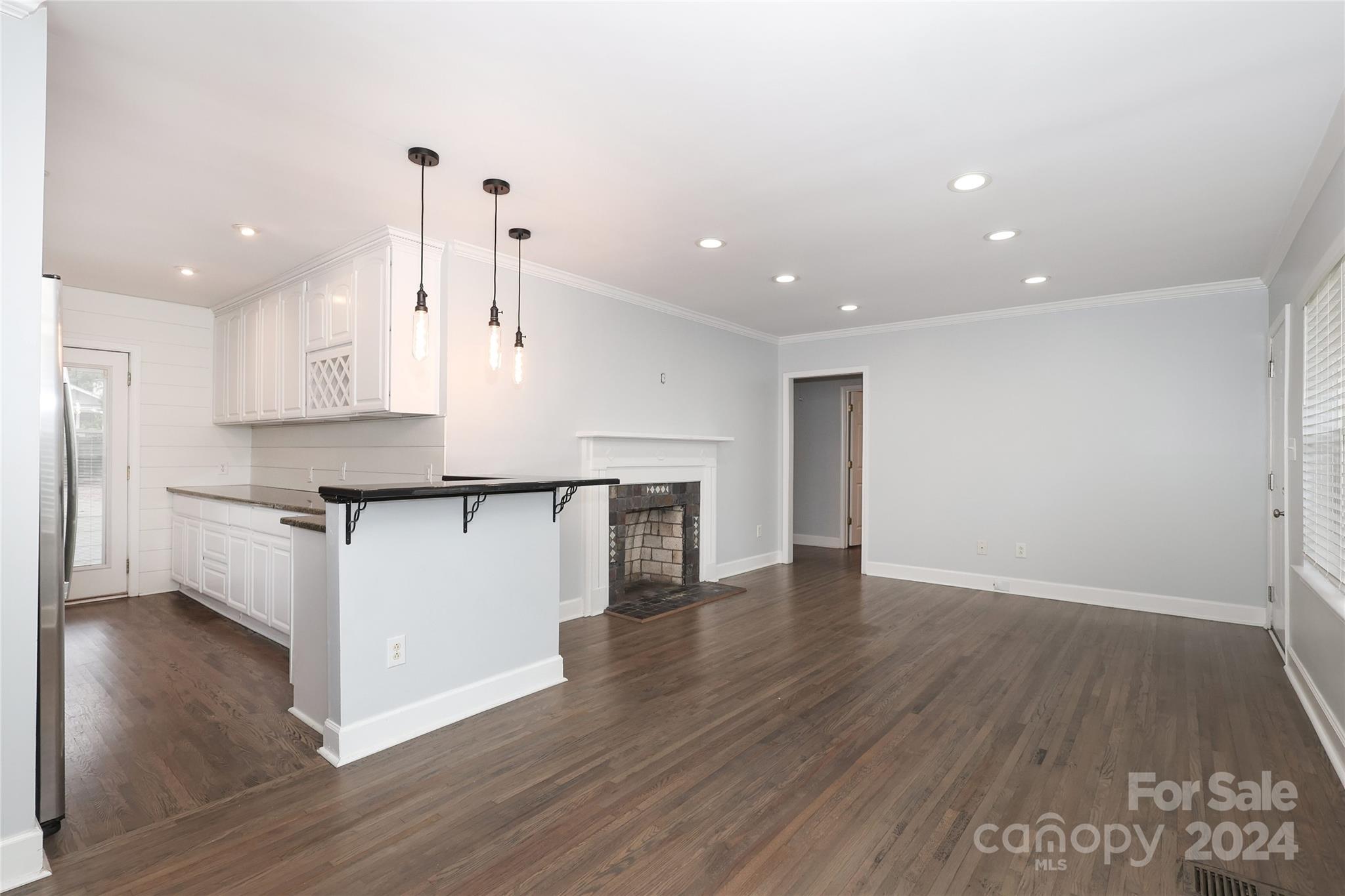 2012 Scott Avenue Charlotte, NC 28203 - Photo 8 of 43 a large kitchen with stainless steel appliances granite countertop a large counter top a sink and a refrigerator