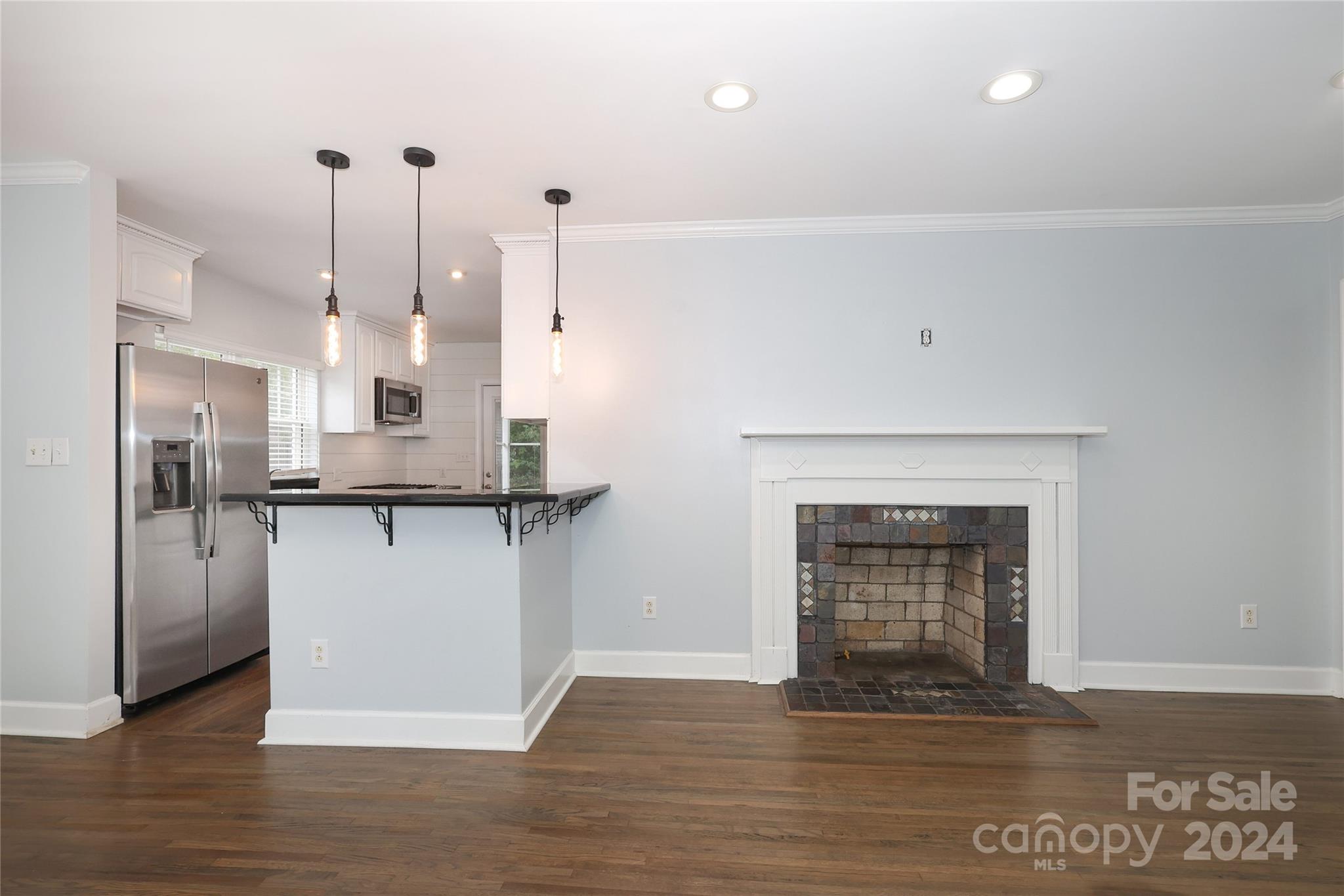 2012 Scott Avenue Charlotte, NC 28203 - Photo 9 of 43 a kitchen with kitchen island a counter top space a sink appliances and cabinets
