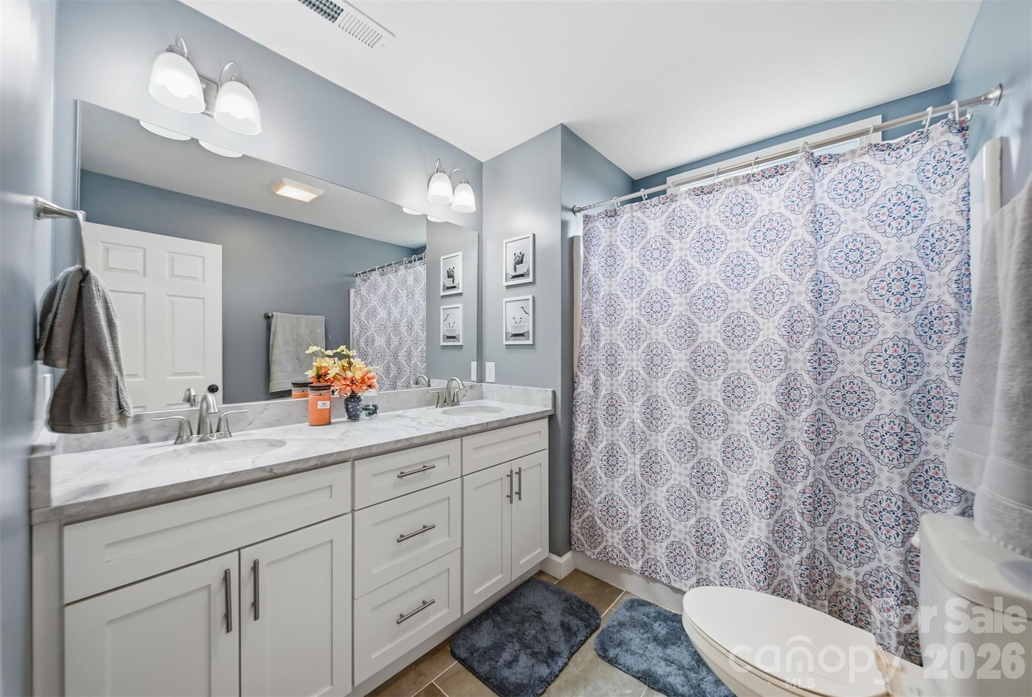 490 Dudley Shoals Road Granite Falls, NC 28630 - Photo 20 of 38 a bathroom with a granite countertop sink a toilet a mirror a shower and vanity
