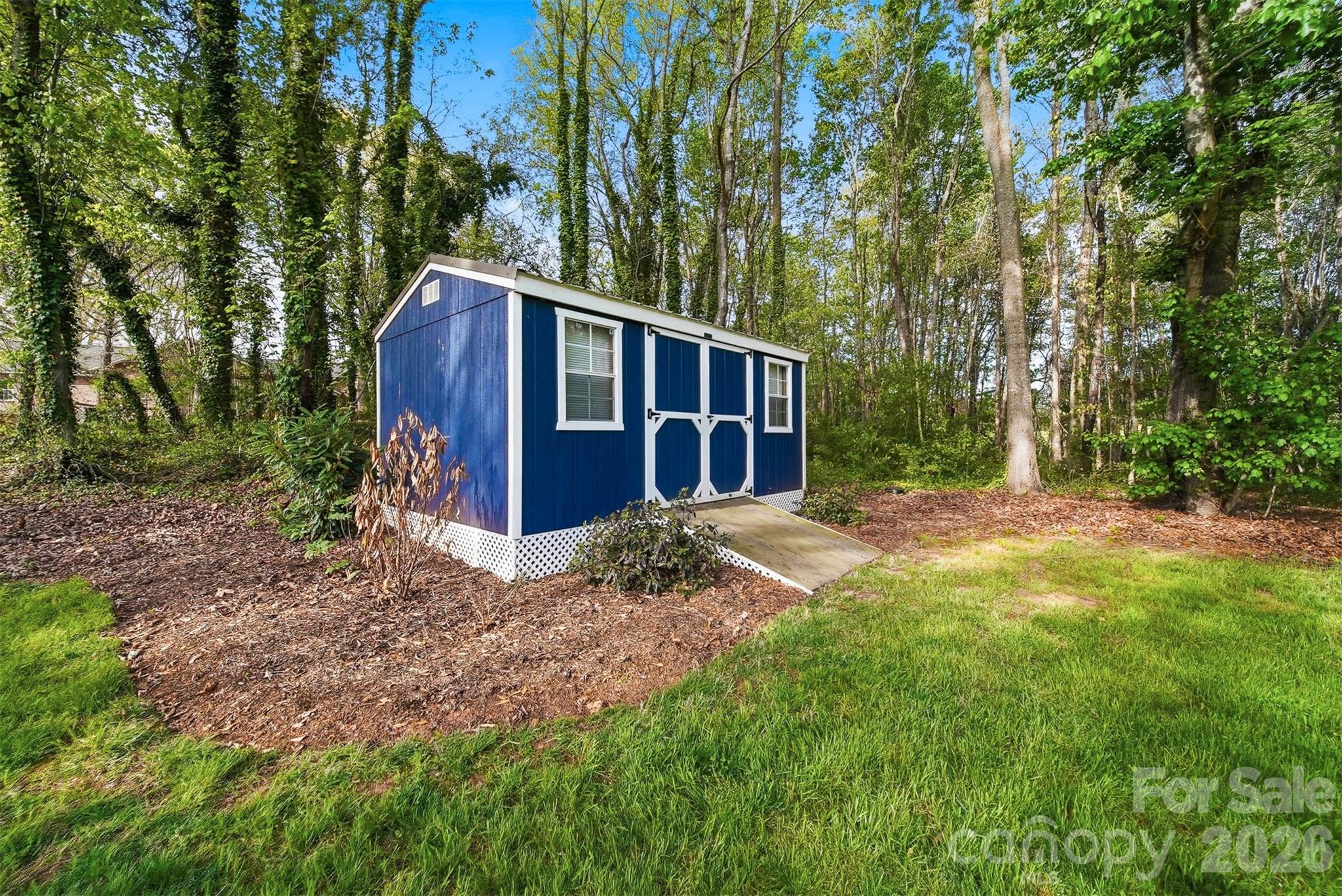490 Dudley Shoals Road Granite Falls, NC 28630 - Photo 28 of 38 a view of a house with backyard and trees