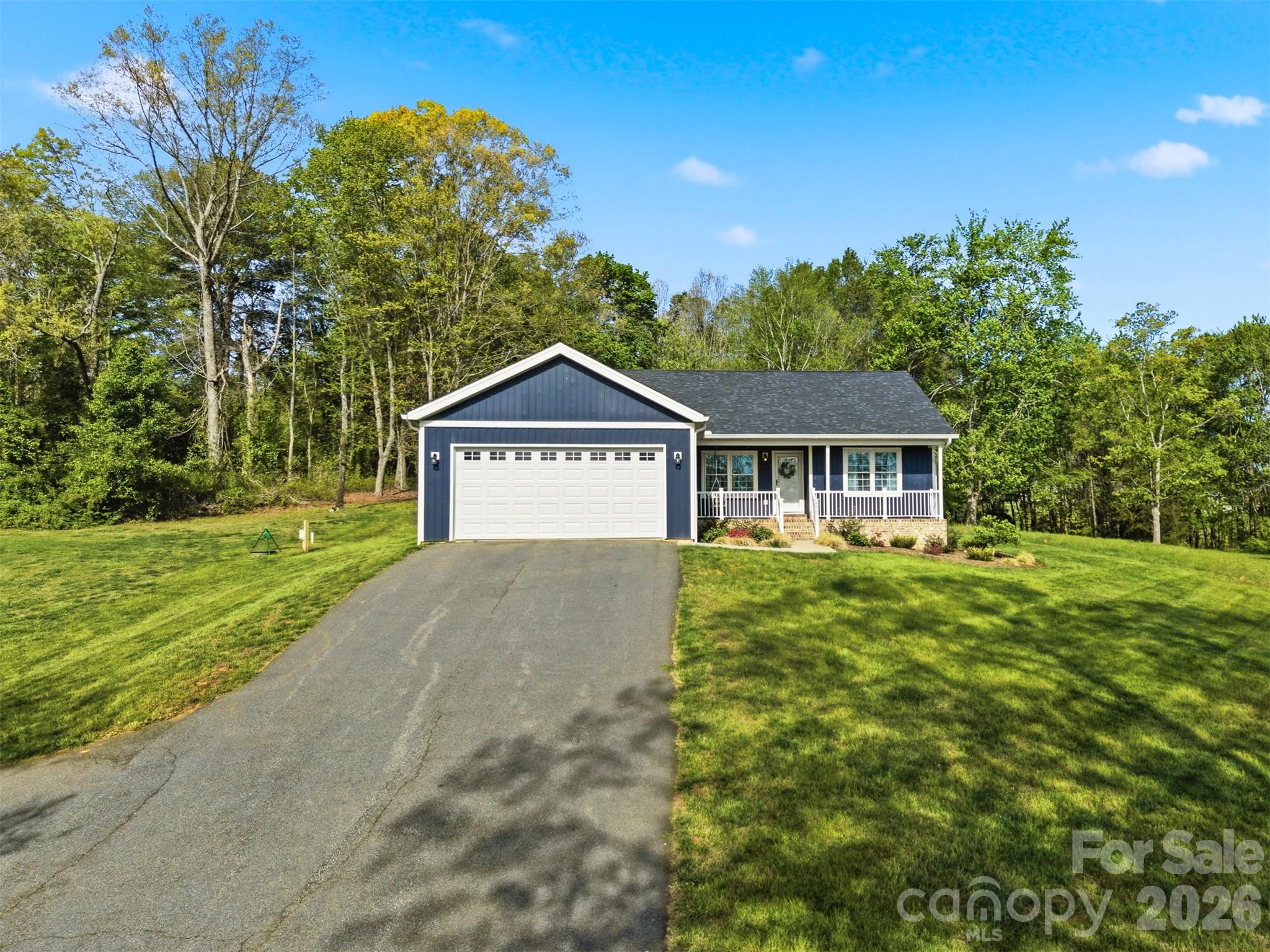 490 Dudley Shoals Road Granite Falls, NC 28630 - Photo 32 of 38 a house with green field in front of it