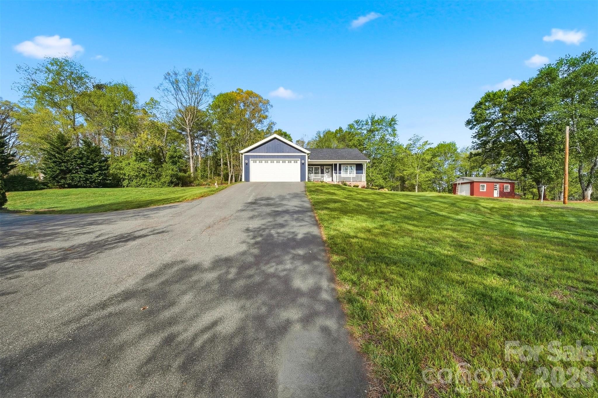 490 Dudley Shoals Road Granite Falls, NC 28630 - Photo 33 of 38 a view of a house with a big yard and palm trees