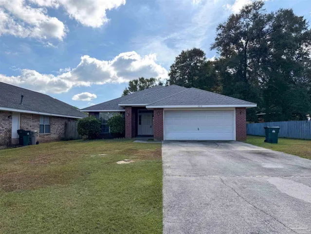a view of a house with a backyard and a tree