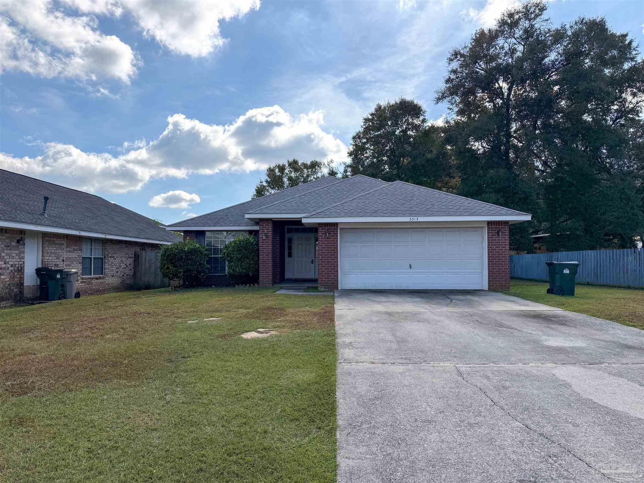 a view of a house with a backyard and a tree