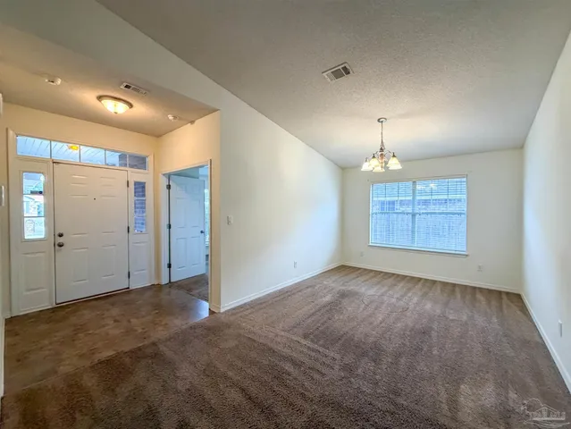 an empty room with closet and windows