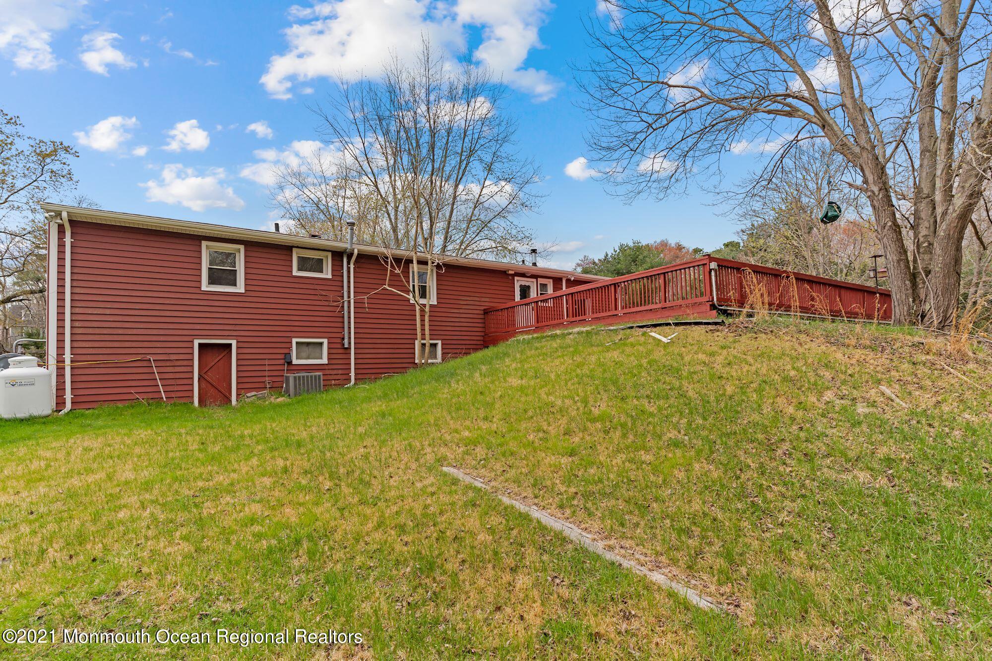 128 Hickory Road Jackson, NJ 08527 - Photo 2 of 25 a view of a backyard with plants and large trees
