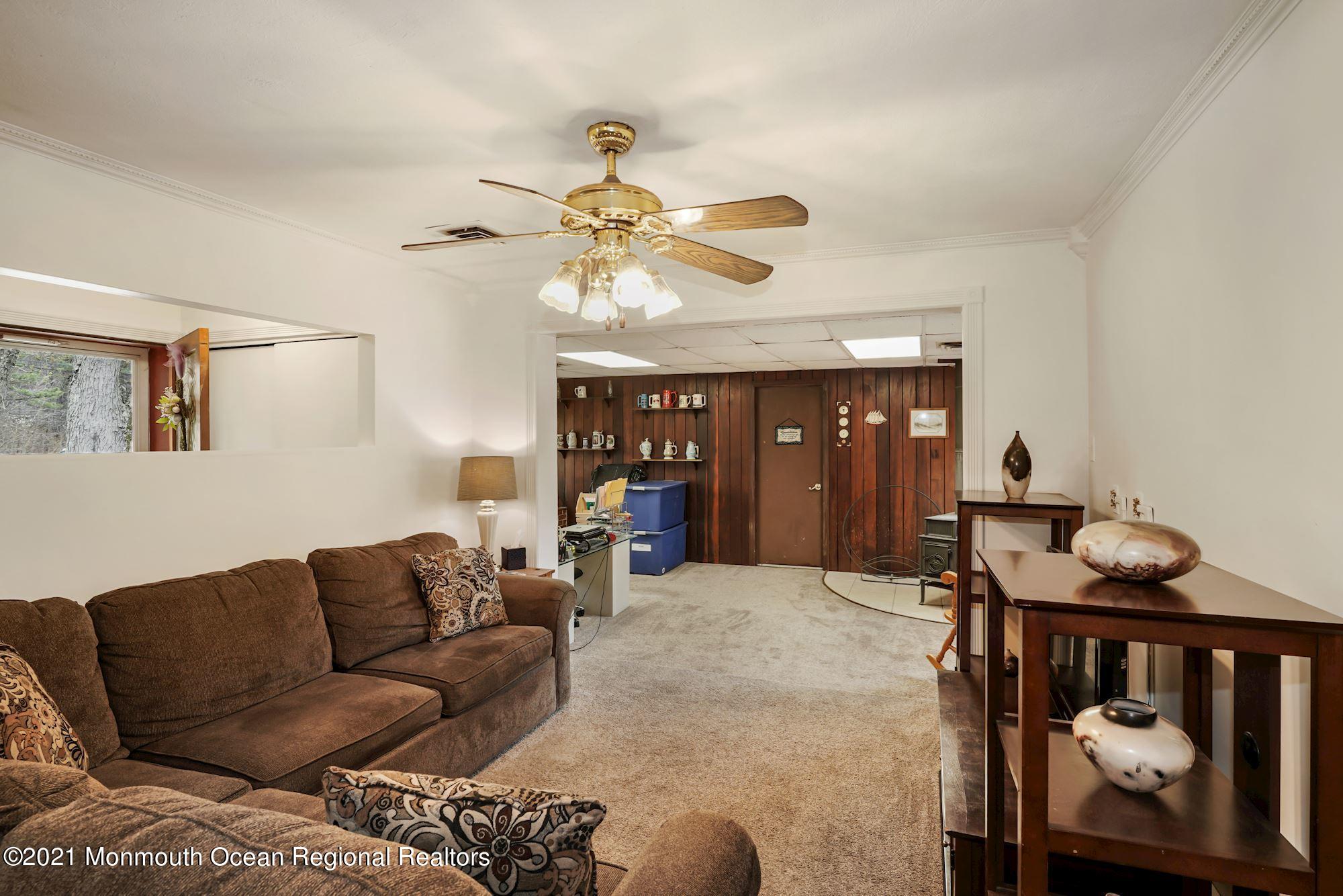 128 Hickory Road Jackson, NJ 08527 - Photo 12 of 25 a living room with furniture a ceiling fan and a rug
