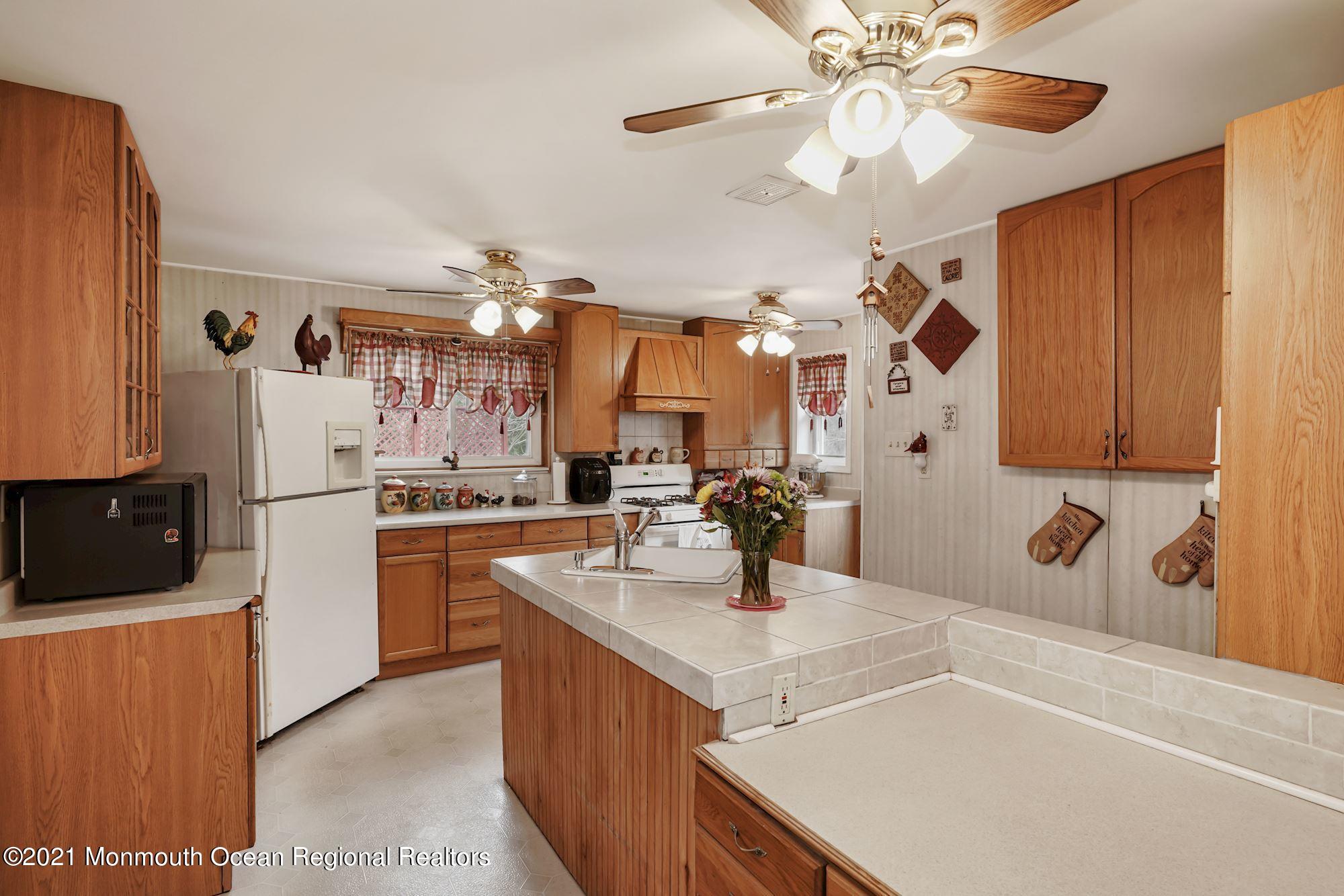 128 Hickory Road Jackson, NJ 08527 - Photo 15 of 25 a kitchen with a sink a counter top space and appliances