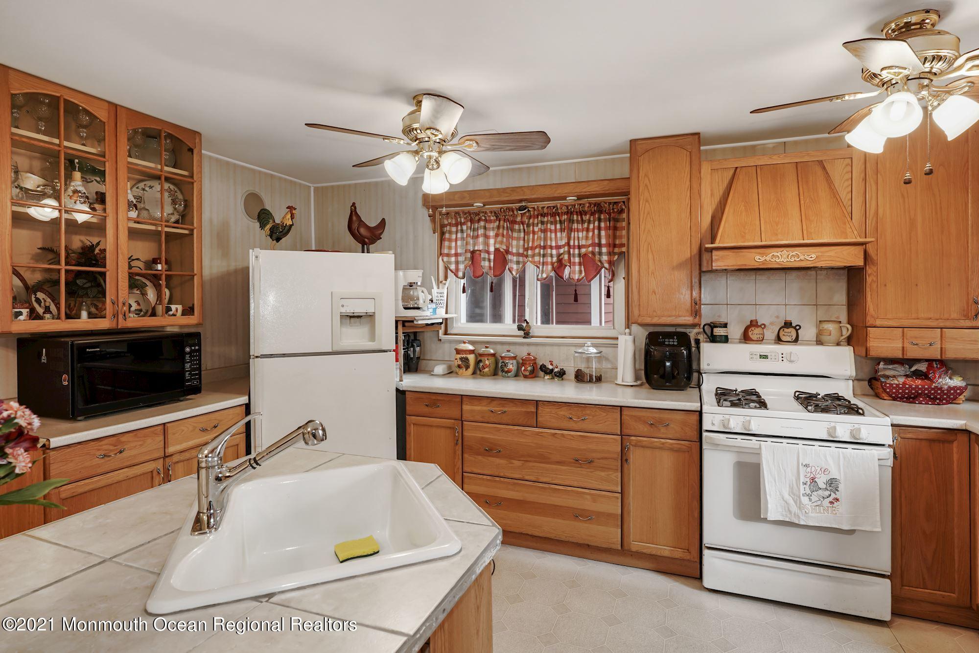 128 Hickory Road Jackson, NJ 08527 - Photo 17 of 25 a kitchen with sink cabinets and window