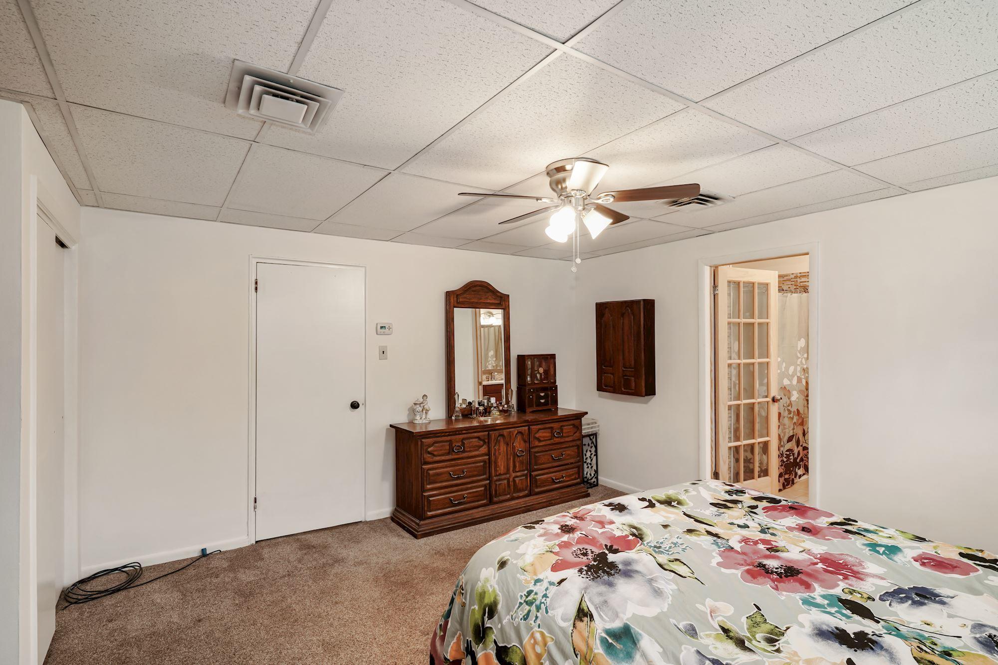 128 Hickory Road Jackson, NJ 08527 - Photo 20 of 25 a bedroom with a large bed and a chandelier