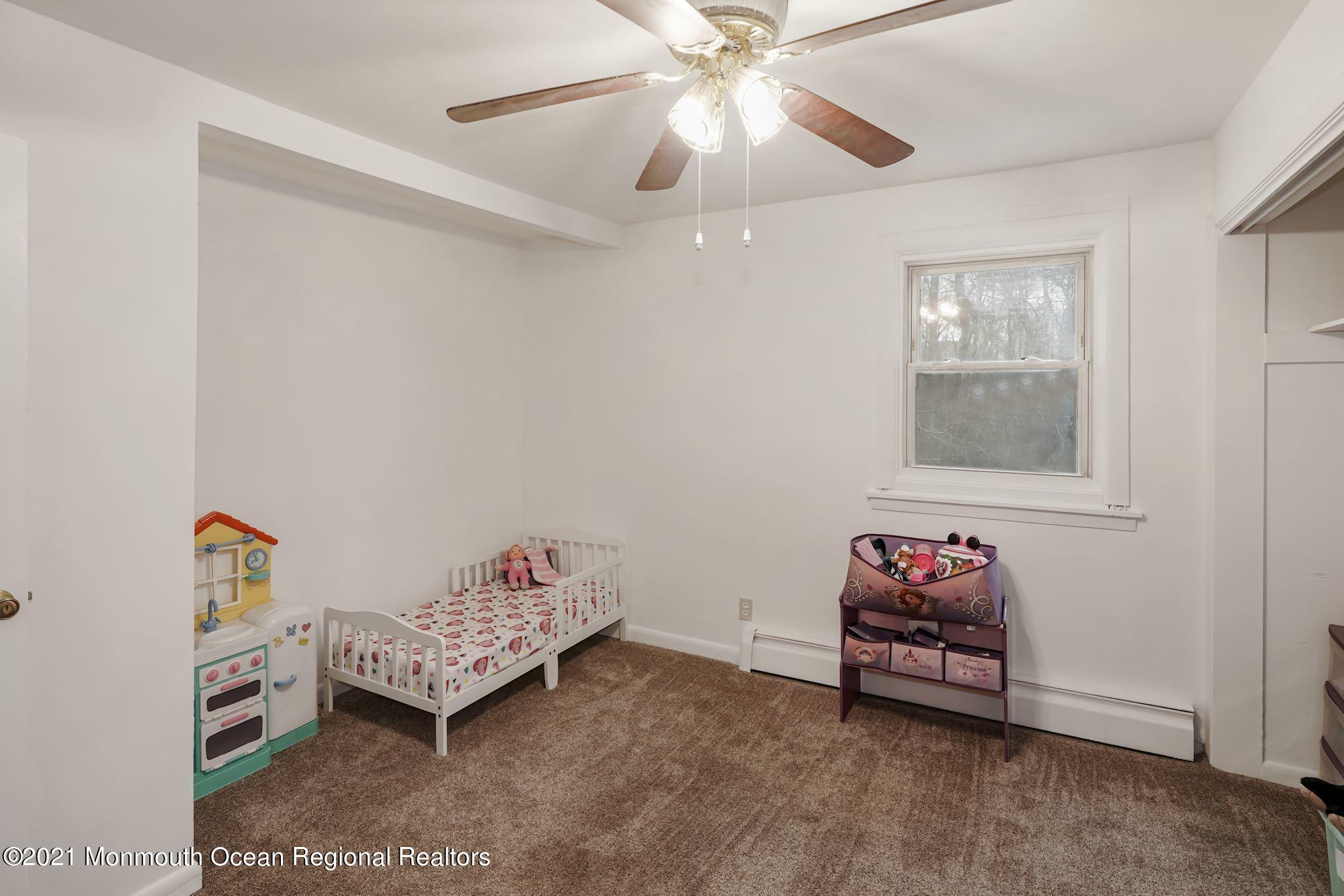 128 Hickory Road Jackson, NJ 08527 - Photo 22 of 25 a bedroom with furniture and a window