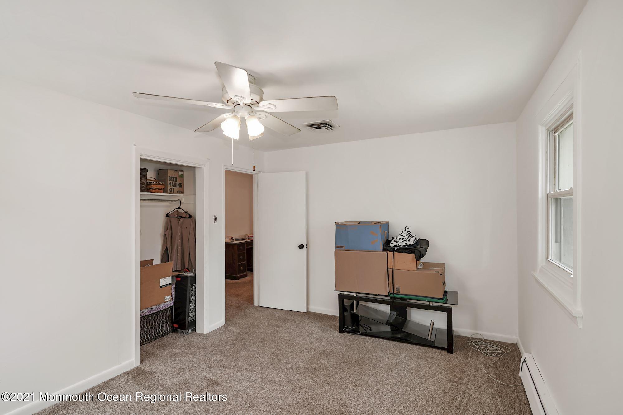 128 Hickory Road Jackson, NJ 08527 - Photo 24 of 25 a room with furniture and a chandelier fan