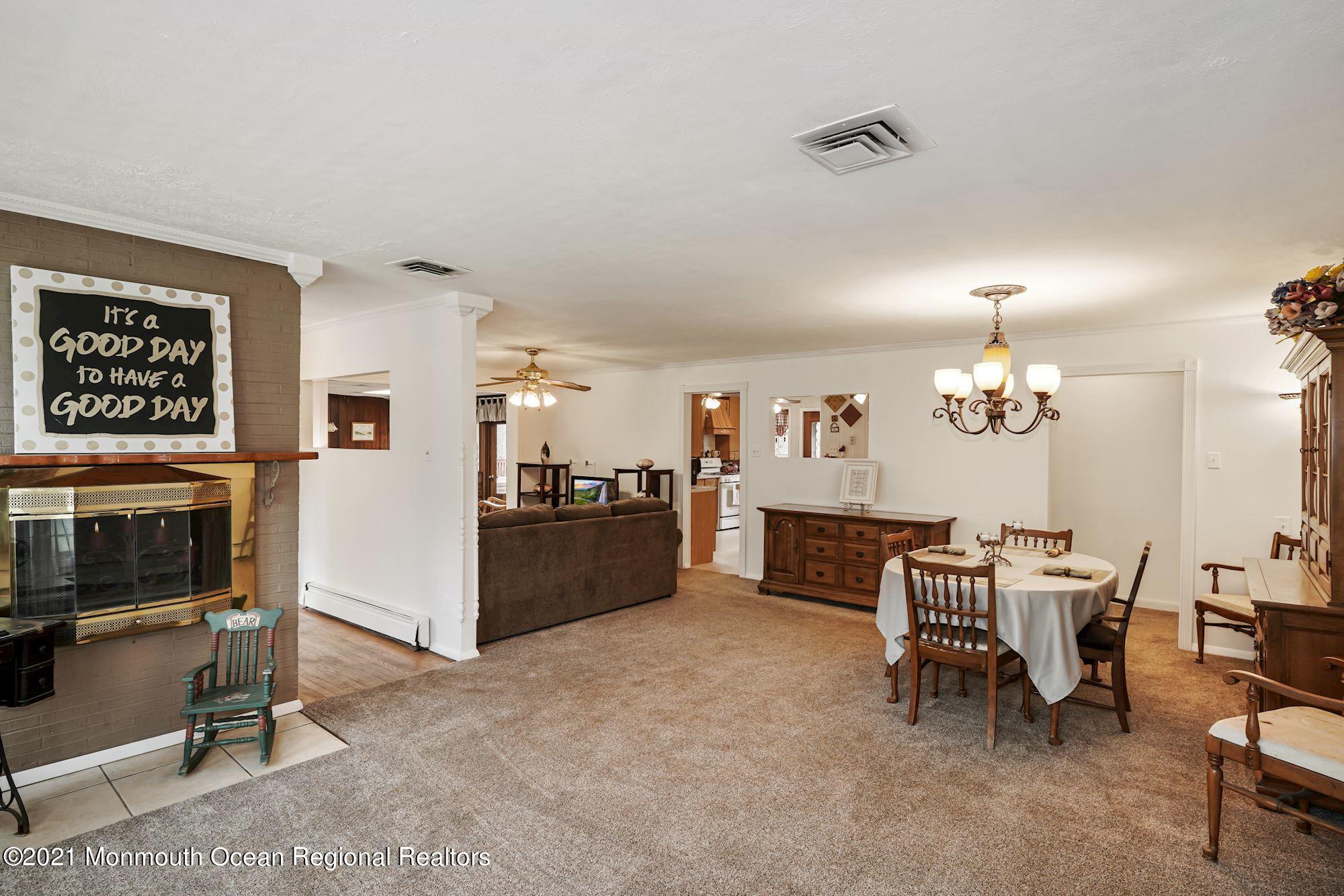 128 Hickory Road Jackson, NJ 08527 - Photo 8 of 25 a living room with furniture and a chandelier