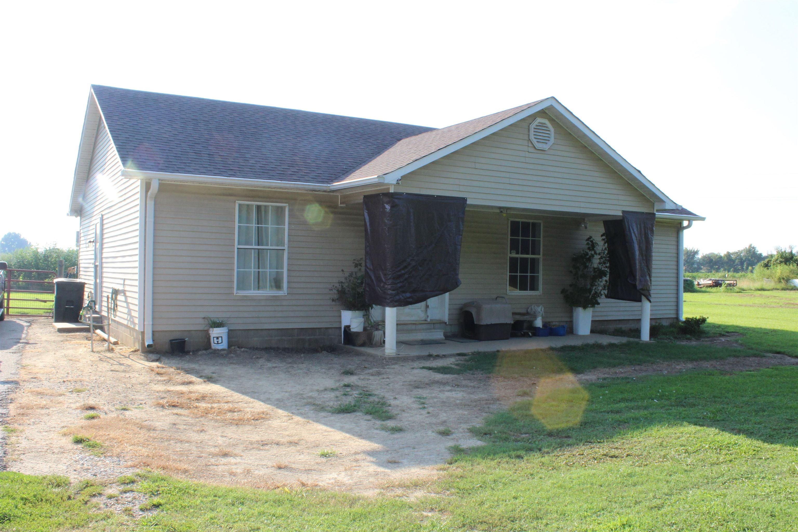 a view of a house with backyard porch and sitting area