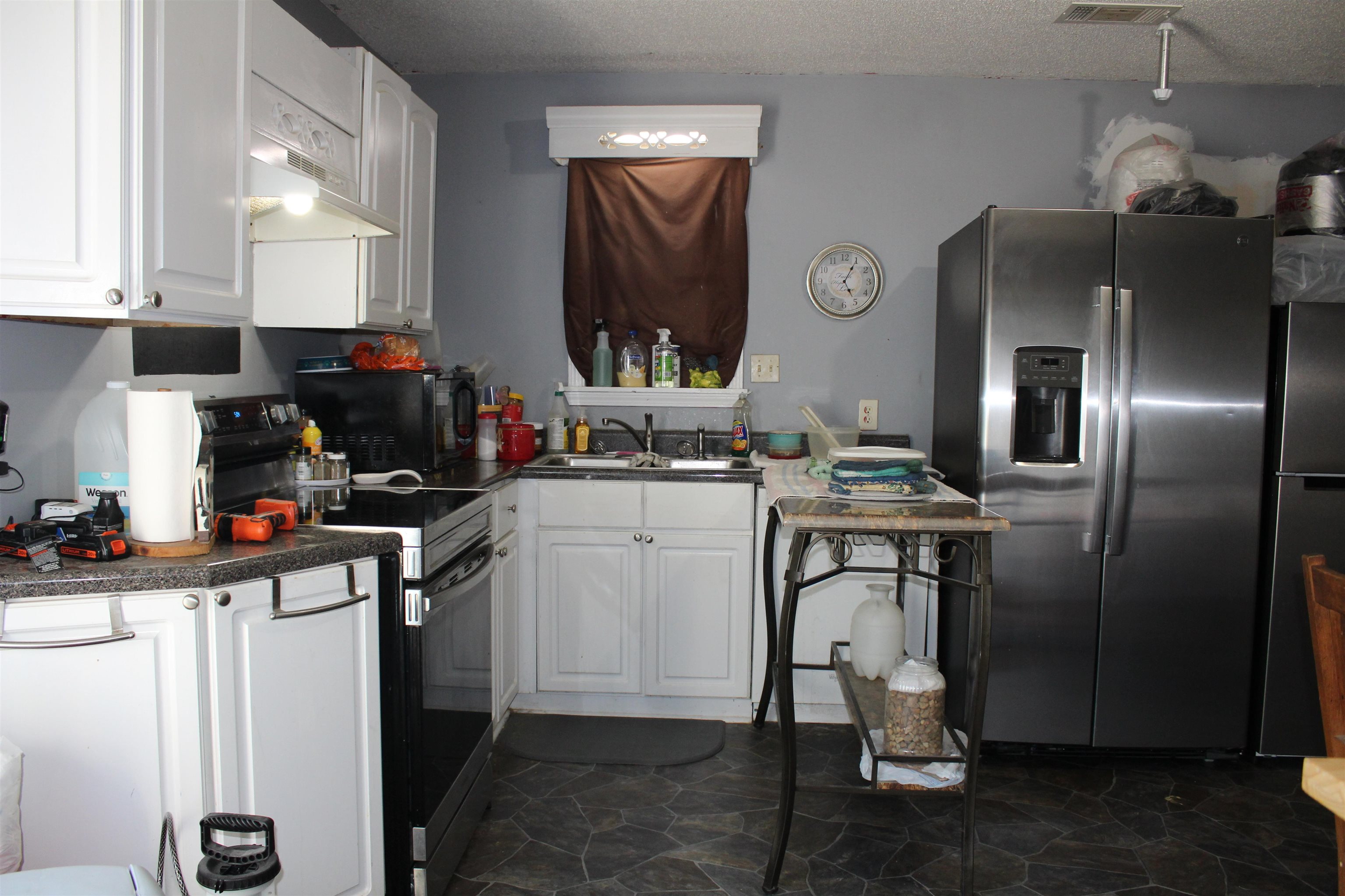 1039 Hyde Road Ripley, TN 38063 - Photo 4 of 21 a kitchen with a sink stainless steel appliances and cabinets