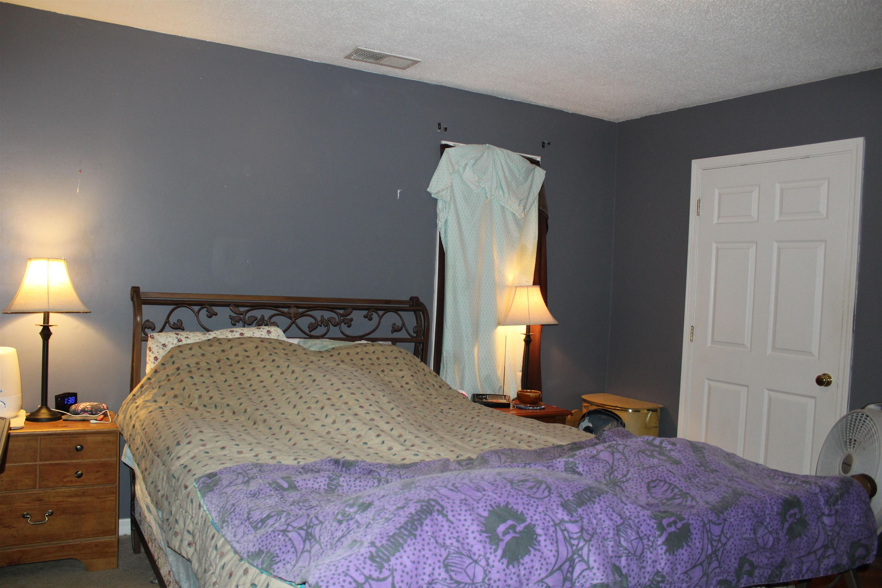 1039 Hyde Road Ripley, TN 38063 - Photo 10 of 21 a bedroom with a bed and a dresser next to a window