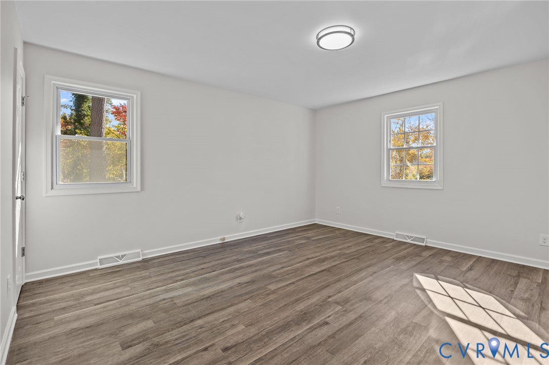 114 Huntington Road Colonial Heights, VA 23834 - Photo 15 of 40 an empty room with wooden floor and windows