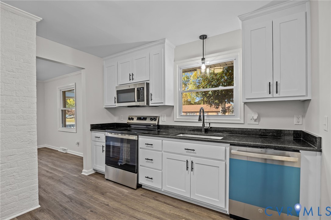 114 Huntington Road Colonial Heights, VA 23834 - Photo 7 of 40 a kitchen with stainless steel appliances granite countertop a stove a sink and white cabinets