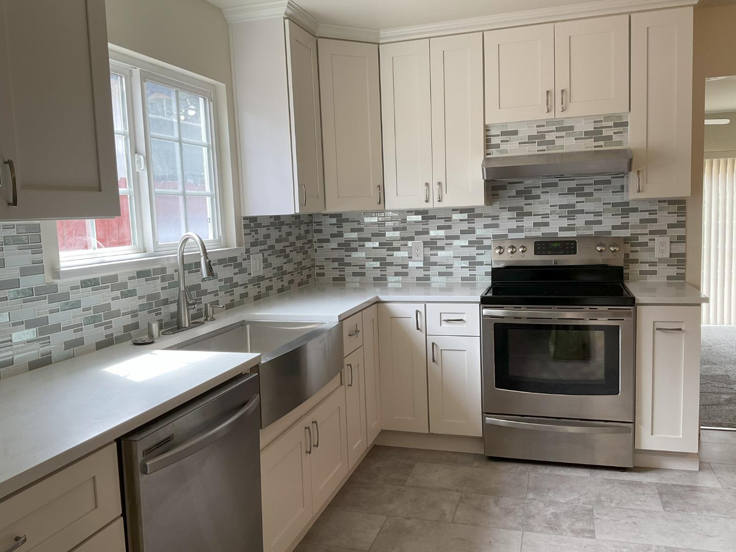 3057 Berney Drive Marina, CA 93933 - Photo 11 of 24 a kitchen with granite countertop white cabinets and stainless steel appliances