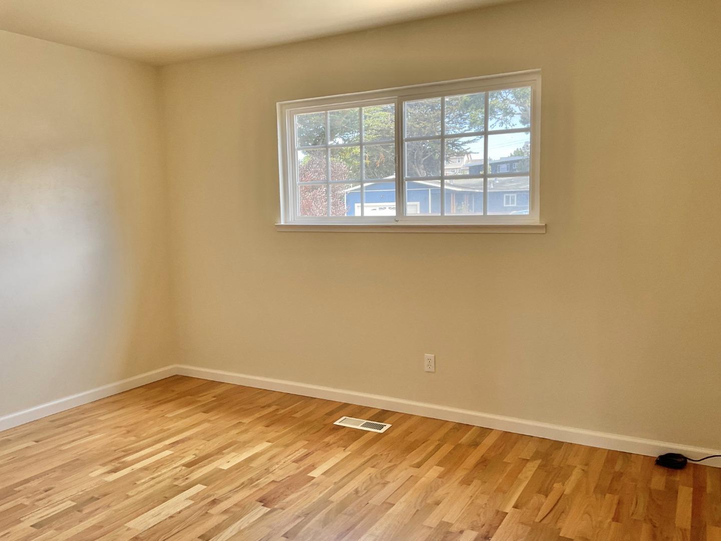 3057 Berney Drive Marina, CA 93933 - Photo 16 of 24 a view of an empty room with wooden floor and a window