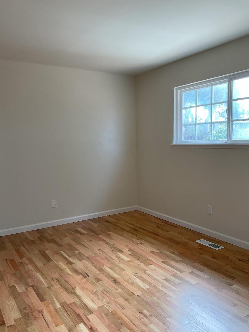 3057 Berney Drive Marina, CA 93933 - Photo 18 of 24 a view of an empty room with wooden floor and a window