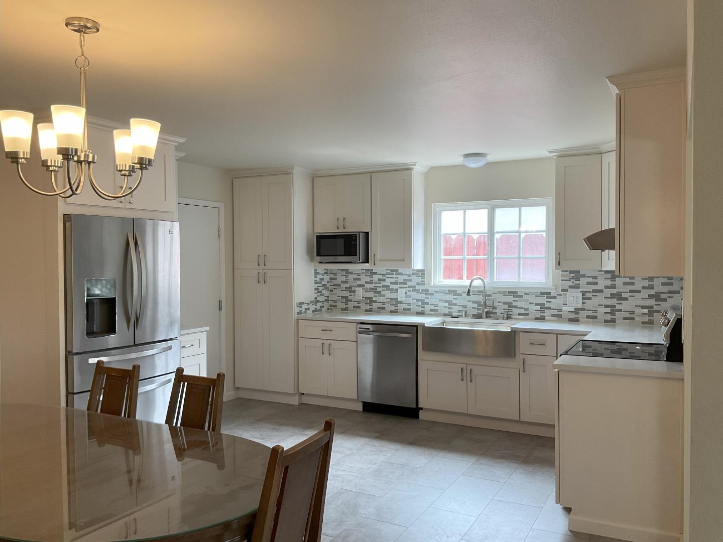 3057 Berney Drive Marina, CA 93933 - Photo 3 of 24 a kitchen with granite countertop a sink stainless steel appliances and cabinets