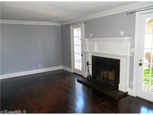 4925 Tower Road, Unit B Greensboro, NC 27410 - Photo 4 of 16 Living Room. Windowed Doors Flank the Living Room Fireplace and Open to an Almost "Old World" Feeling Garden Space and Patio