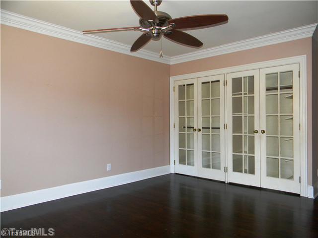 4925 Tower Road, Unit B Greensboro, NC 27410 - Photo 5 of 16 Master Bedroom. The Master Features a Tasteful Ceiling Fan, Great Closet Built-Ins through the Windowed Doors.