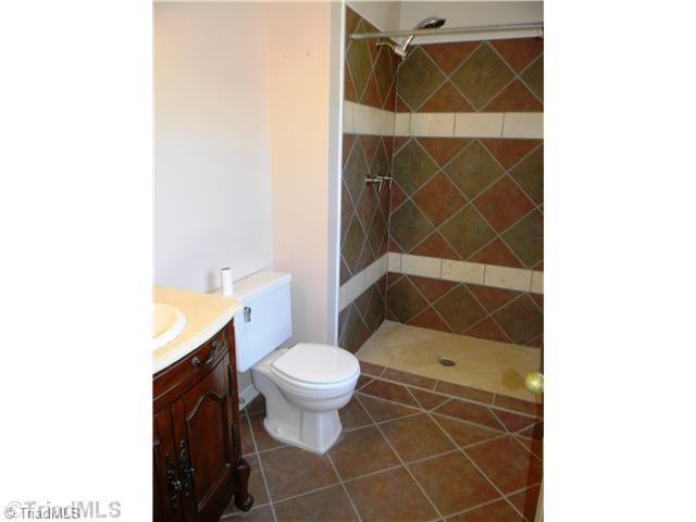 4925 Tower Road, Unit B Greensboro, NC 27410 - Photo 6 of 16 Master Bath/Spa. The Master s Bath Features a Bombay Styled Marble Countered Vanity along and a Tiled Step-In Shower