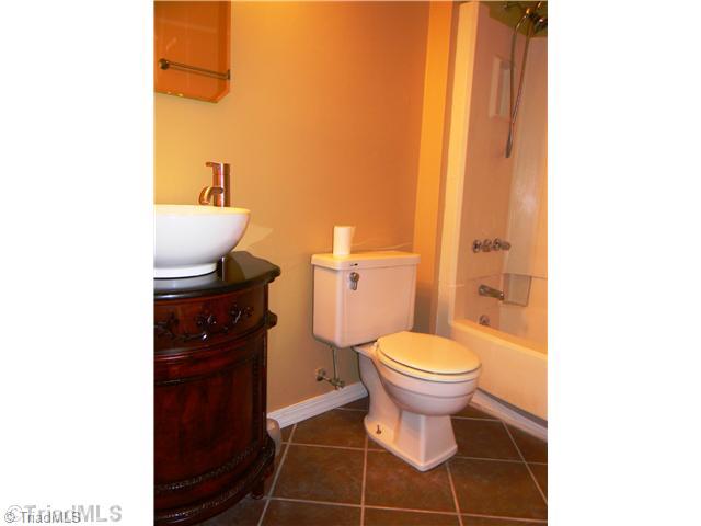 4925 Tower Road, Unit B Greensboro, NC 27410 - Photo 8 of 16 Other Bath. Your Guests will Enjoy the Luxurious Tiled Guest Bath along with the Vessel Sink on the Beautiful Detailed Vanity