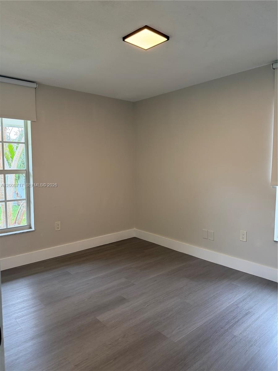 9760 Southwest 210th Street Cutler Bay, FL 33189 - Photo 2 of 17 an empty room with wooden floor and windows