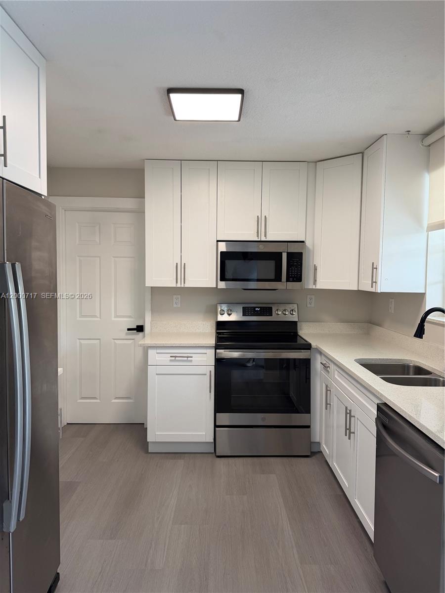 9760 Southwest 210th Street Cutler Bay, FL 33189 - Photo 4 of 17 a kitchen with a sink stove and refrigerator