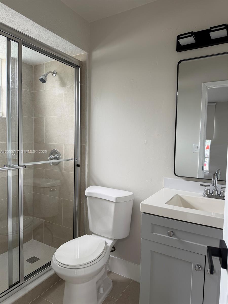 9760 Southwest 210th Street Cutler Bay, FL 33189 - Photo 6 of 17 a bathroom with a toilet a sink and shower
