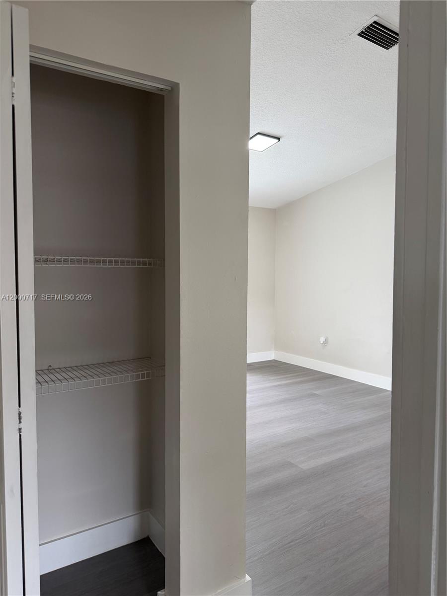 9760 Southwest 210th Street Cutler Bay, FL 33189 - Photo 8 of 17 a view of a room with wooden floor