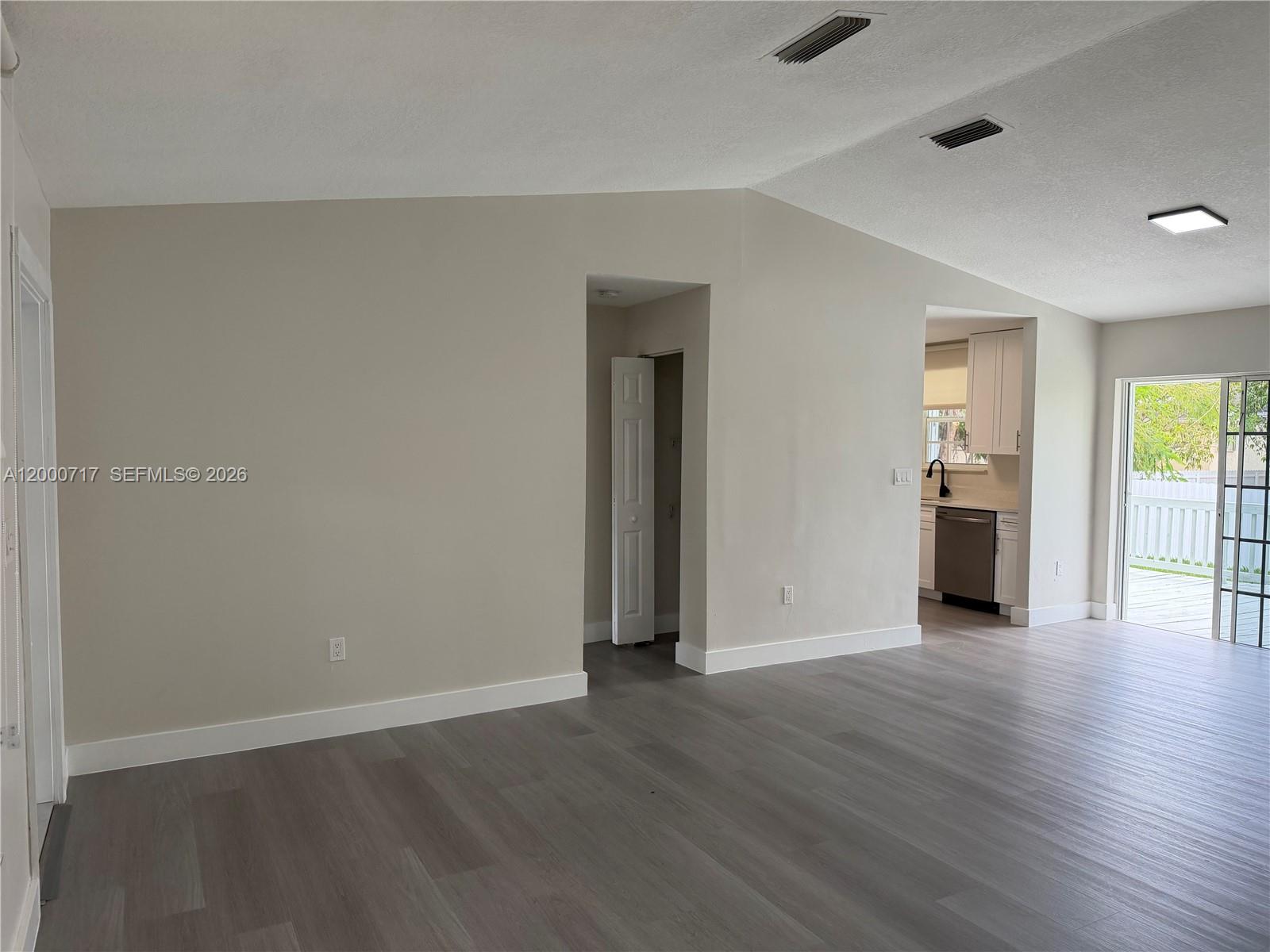 9760 Southwest 210th Street Cutler Bay, FL 33189 - Photo 9 of 17 an empty room with wooden floor and windows