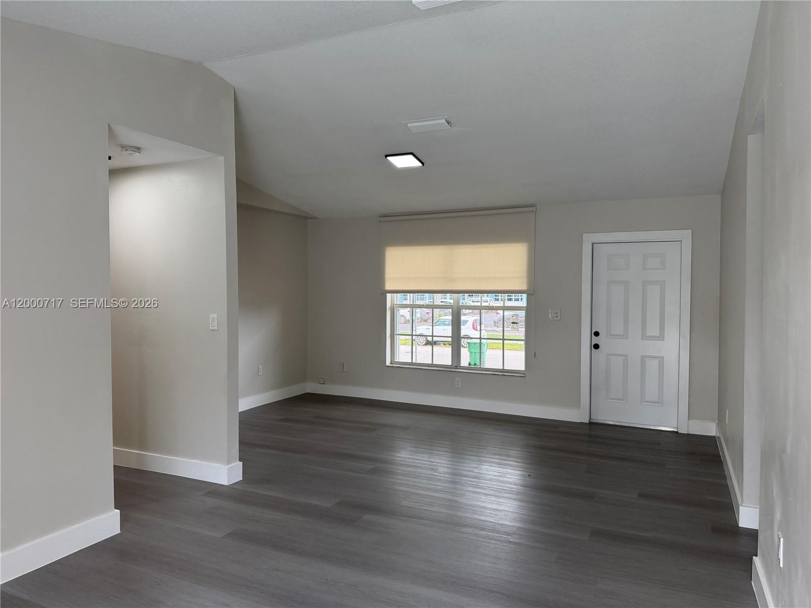 9760 Southwest 210th Street Cutler Bay, FL 33189 - Photo 10 of 17 an empty room with wooden floor and windows
