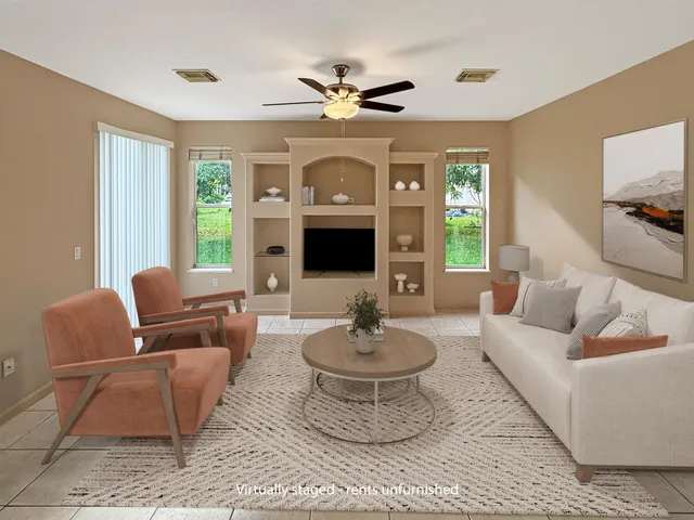 a living room with furniture a flat screen tv and a large window