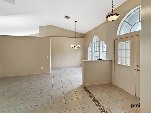 a kitchen with granite countertop a refrigerator and a stove top oven
