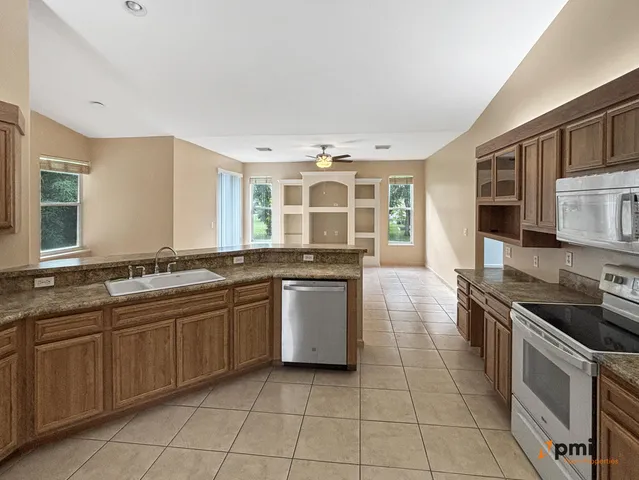 a view of a kitchen with furniture and chandelier