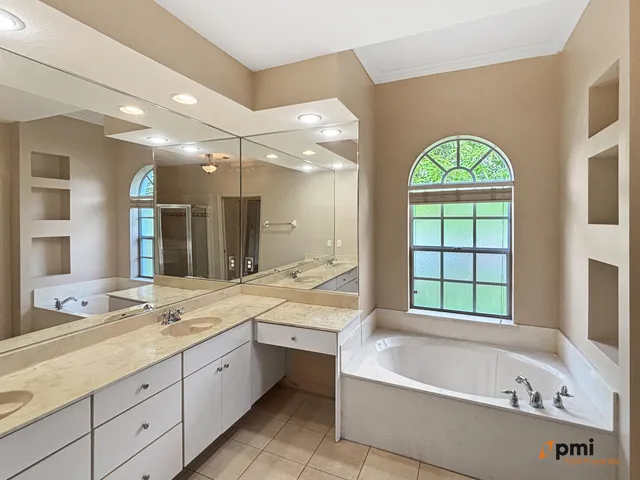 a view of a hallway with a chandelier fan and windows
