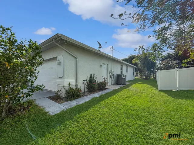 a view of an house with backyard space and balcony