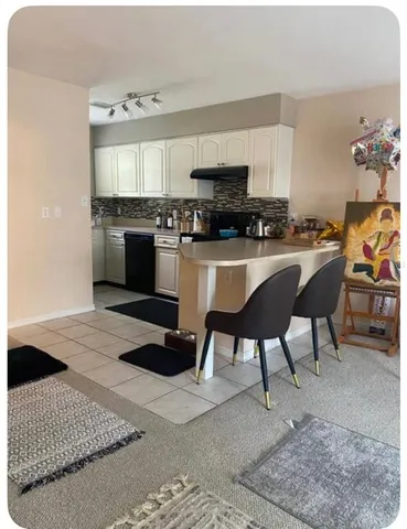 a kitchen with stainless steel appliances kitchen island granite countertop a sink and a stove
