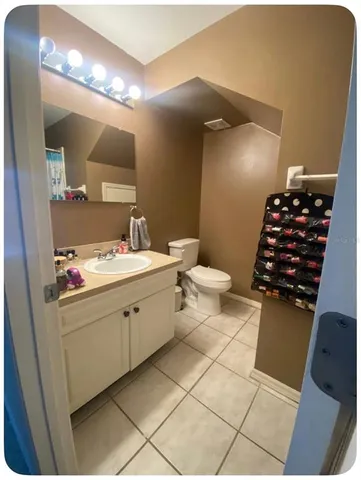 a bathroom with a sink toilet and a mirror
