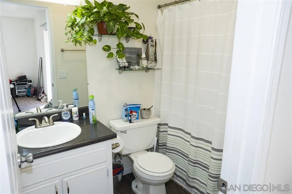 715 B Street Ramona, CA 92065 - Photo 20 of 21 a bathroom with a sink a toilet and a mirror