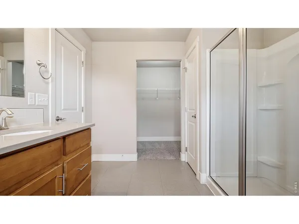 a bathroom with a sink a mirror and a shower